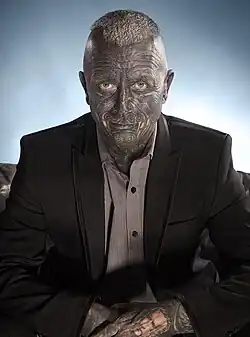 Franz seated, wearing a suit