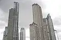 A photo showing most of the neighborhood of Puerto Madero's known highrise, with the El Faro Towers (back right) in the background.