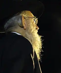 Religious Jew with beard and payot tucked behind ear