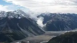 South aspect of Lauper Peak (left) rises above the Rakaia River Valley, with Whitcombe Pass filled with clouds.