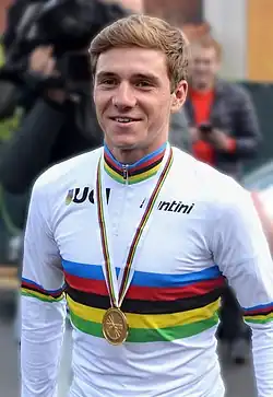 Remco Evenepoel wearing UCI world champion's jersey with rainbow bands.