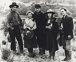 Group portrait of the cast in Western costumes, including Hart and Chaney
