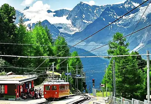 A wider view of the station, with the track of the Riffelalp tram visible beside the station building