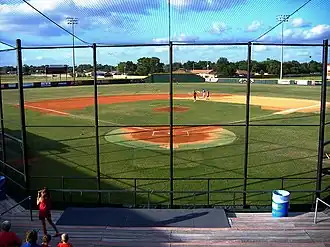 A view of a baseball diamond from the seats behind home plate.