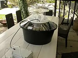 A large circular machine sitting on an outdoor table