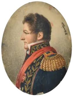 "Half length painted portrait of a man with curly auburn hair and sideburns facing left and wearing an elaborate military tunic embroidered in gold with heavy epaulettes, high embroidered collar and a red sash."