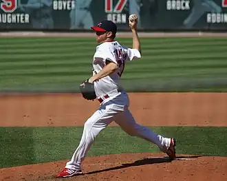 A man in a white baseball uniform