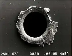 Image 45View of an orbital debris hole made in the panel of the Solar Max satellite (from Space debris)