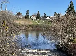Mouth of Pierre-Paul River, Batiscan River, bridge P01548, reinforced concrete girders (1950),[3] Route 352, spires of the bell towers of the Catholic church, village, cultivated field, cemetery Curé Adélard-Lamy,[8] Saint-Adelphe