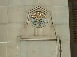 An anchor and caduceus on the exterior of a building
