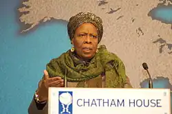 Colour photo of a woman standing behind a lectern