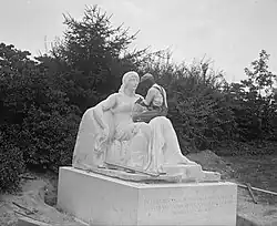 A man working on the installation of the sculpture