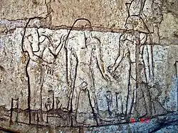 Shoshenq III, standing on the boat "msktt", the boat of the night, with the god Atum. From his tomb in Tanis.