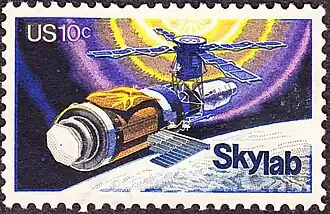 Skylab commemorative stamp, issue of 1974. The commemorative stamp reflects initial repairs to the station, including the parasol sunshade.