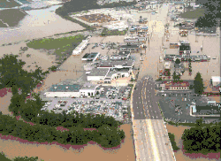 Aerial view of flooded businesses along a thoroughfare.