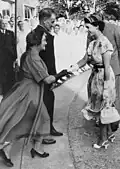 The wife of Australian politician Walter Cooper curtsying to Queen Elizabeth II, 1954.