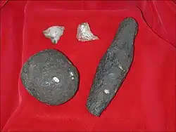 Stone tools of the Developed Olduwan from Cooper's D. Pictured are a hammerstone, an unknown object made of shale, and quartz flake tools