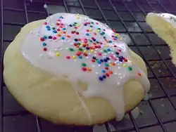 Dropped sugar cookie with a powdered sugar glaze and sprinkles