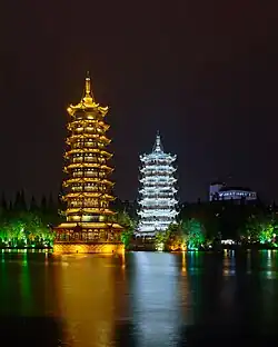 The Sun and Moon Pagodas lighted at night and reflected in Lake Shanhu in November 2017.