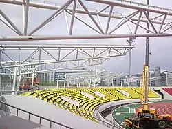 The white, robust frames of canopy are standing above the ground of Tancheon stadium. It was 2009 when the Tancheon Stadium was under refurbishment for canopy installation.