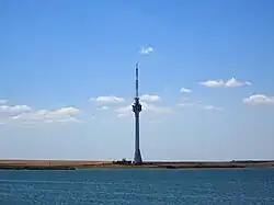 Photo of the Techirghiol TV tower in front of a lake