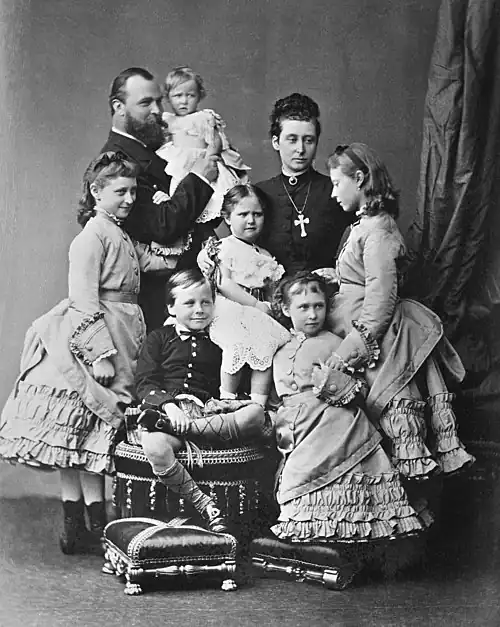 The Hessian family in May 1875: (clockwise from far left): Princess Elisabeth, Grand Duke Ludwig holding Princess Marie, Grand Duchess Alice, Princesses Victoria and Irene, Prince Ernest, and Princess Alix in the center.