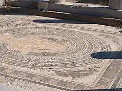 A close-up view of the floor mosaic containing a circle-within-a-square design