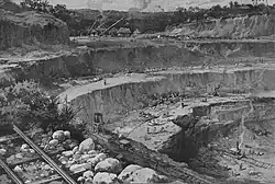 Illustration of a large, terraced excavation