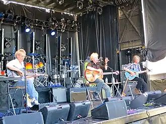 The band seated onstage