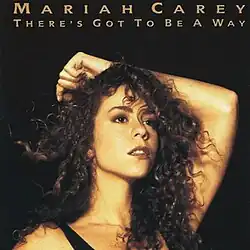 A woman with curly hair places her left arm behind her head