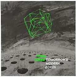 A box drawn from a series of green lines against a grey background. Light green bold text to the bottom right reads "Thom Yorke"; white bold text beside it reads "Tomorrow's Modern Boxes".