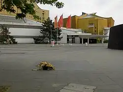 Bus terminal at the Philharmonie, in the foreground a plaque is set into the pavement to commemorate the victims of the Aktion T4