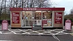 Timpson pod store stood in an outdoor supermarket car park