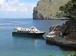 Tourists board a boat in Majorca (Spain) for a coastal trip from Sa Calobra to Port de Soller