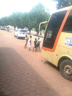 Children standing in front of a bus