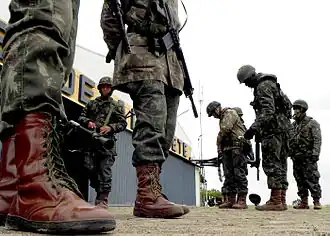 Brazilian soldiers with cobwebbed boot laces using green paracord.