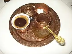 Turkish coffee set containing a cup of coffee, a cezve and a sugar bowl