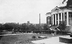 A black and white photograph of a large building with large columns