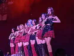 An image of Twice doing the same pose with their hands.