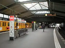 Station with a yellow train and a skylight