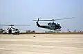 UH-1N Iroquois (Huey) utility helicopter (right) takes off from the flight line at Camp Humphreys.
