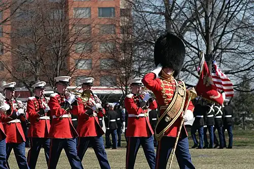 Master Gunnery Sgt Thomas D. Kohl leads the Marine Band during the 60th anniversary of the Battle of Iwo Jima commemoration ceremony at the Marine Corps War Memorial, 2005