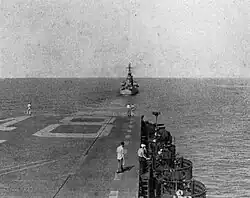 USS Oregon City (CA-122) tows USS Saipan (CVL-48) in the Caribbean Sea, in 1947