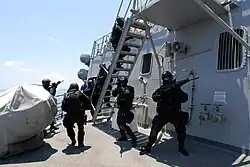 Members of the Brunei Special Forces rush towards the pilot house of USS Howard (DDG-83) during a visit, board, search and seizure exercise, August 2008.