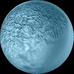 A spherical blueish body with its surface covered by craters and polygons. The lower right part is smooth.