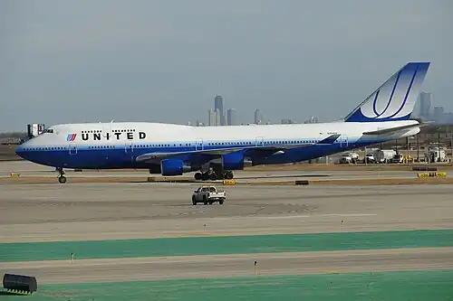 A Boeing 747-400 at O'Hare International Airport in "Rising Blue" or "Blue Tulip" livery (2004–2010)