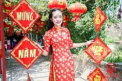 Woman wears an áo dài for Tết in the 21st century.