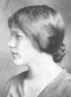 A young white woman, in 3/4 profile, with light hair dressed to the nape, in a low chignon
