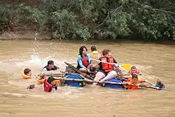 Voortrekker children taking part in a raft race.