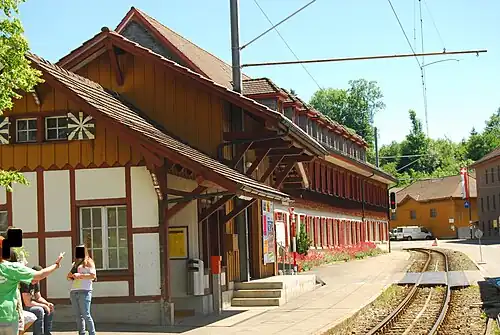 Two-story wooden building with gabled roof